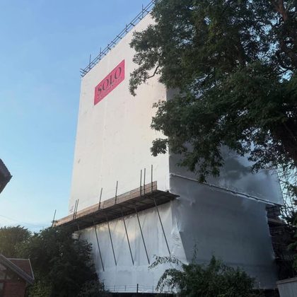 Large commercial building encapsulated in shrink wrap
