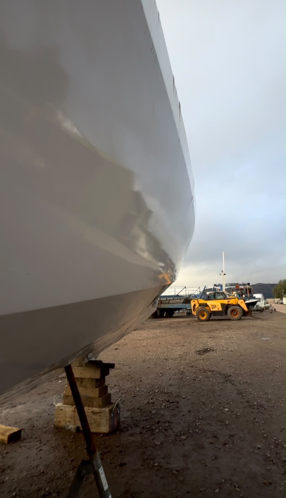 Shrink wrapped hull of the tender in the yard